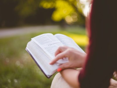 selective focus photography of person reading book